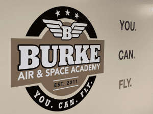Burke Air and Space Academy Poster on the wall and slogan.