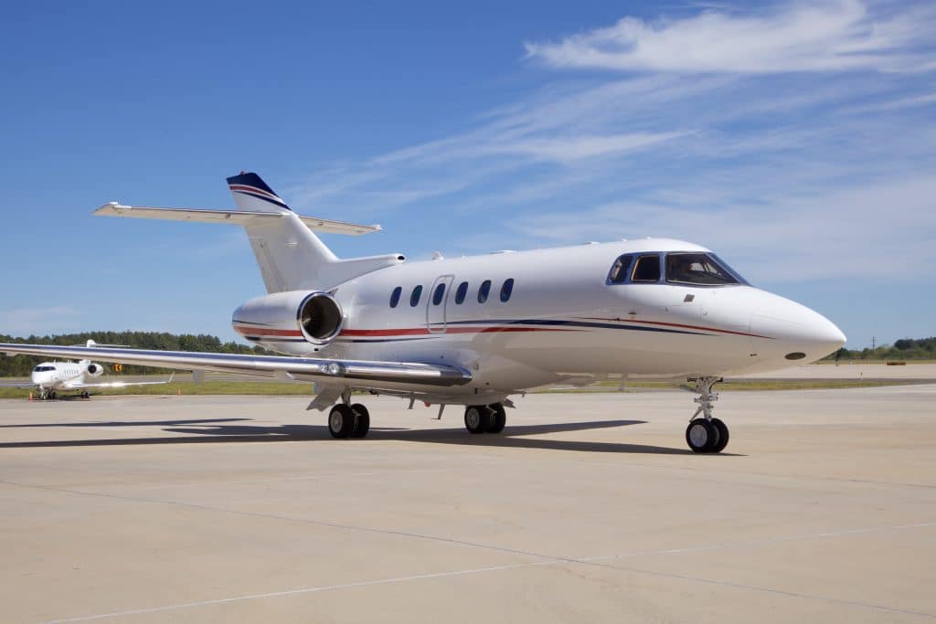 Hawker 900XP midsize private jet aircraft sitting on a runway.